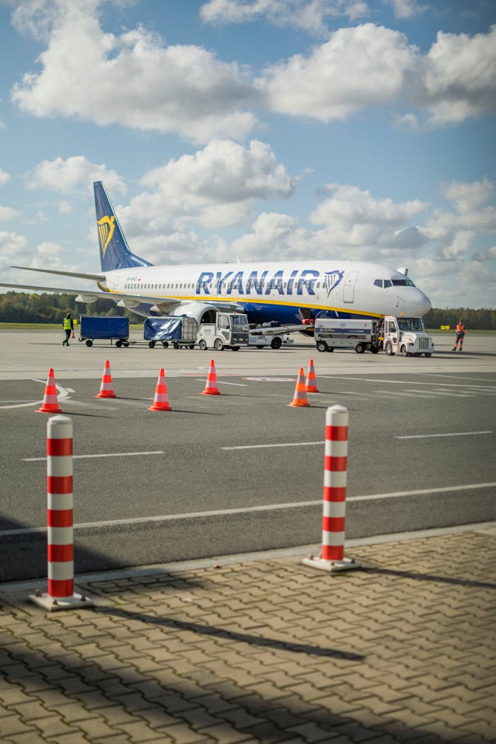 Crafting Captivating Headlines: Your awesome post title goes here Ryanair airplane parked at Wrocław Airport with ground crew and vehicles.
