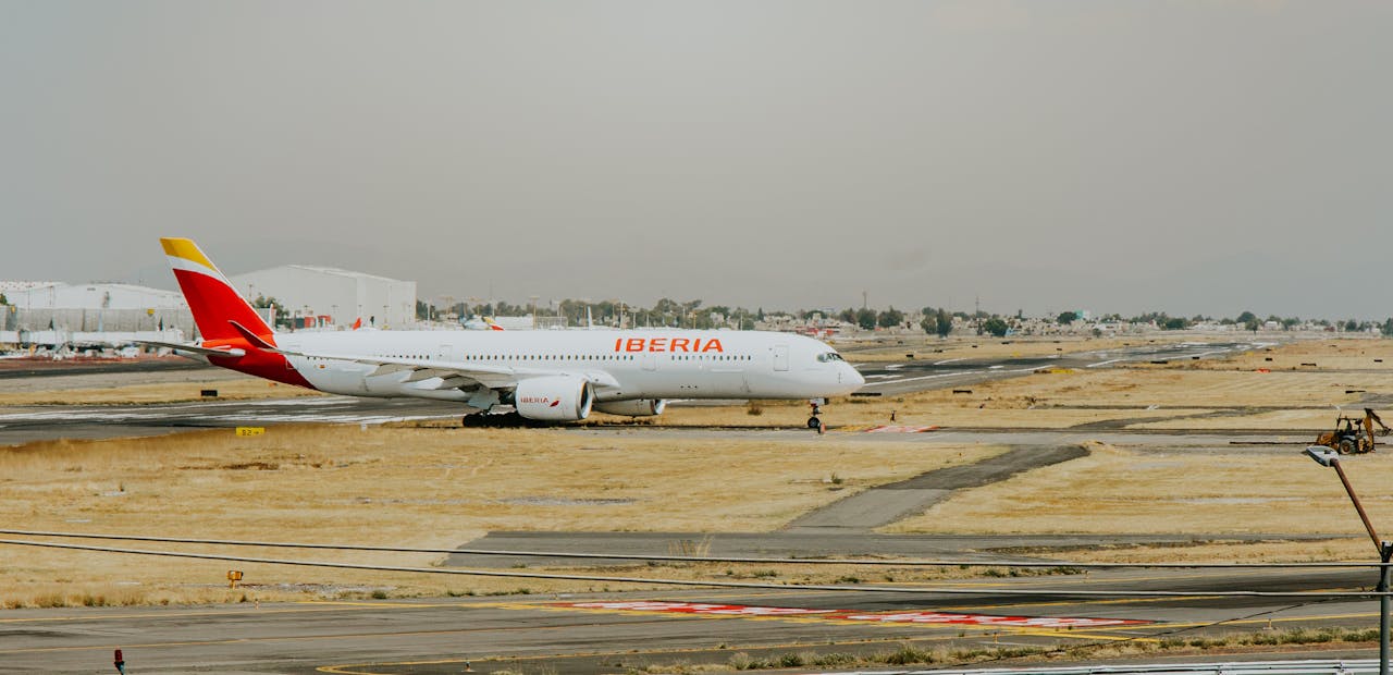 The Art of Drawing Readers In: Your attractive post title goes here Iberia airplane on runway at airport, ready for international travel.