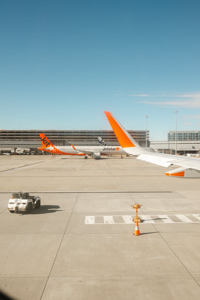 Inicio Jetstar airplanes lined up at Melbourne Airport Terminal 4, showcasing modern aviation.