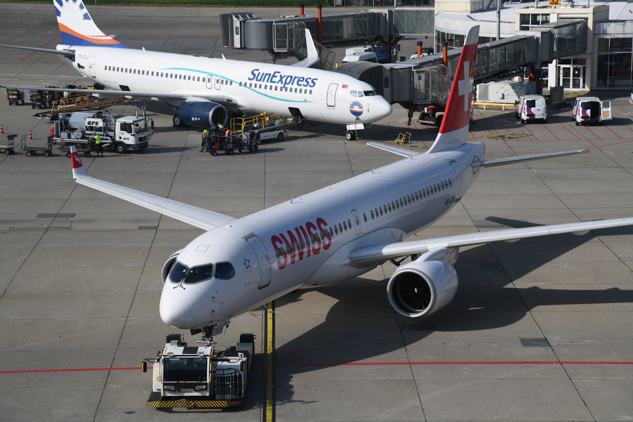 Services Airplanes parked at Geneva airport with Swiss and SunExpress airlines visible.